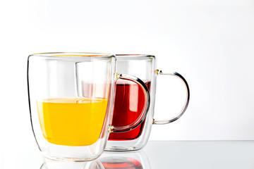 Two cups of yellow and red juice.