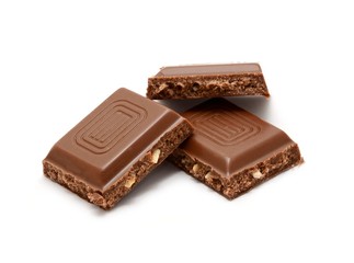 Nut chocolate squares over white background.