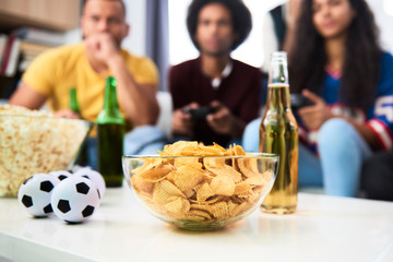 Close up of snack and beer bottle in the table