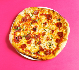 pepperoni pizza on pink background.top view. isolated pizza whole pizza