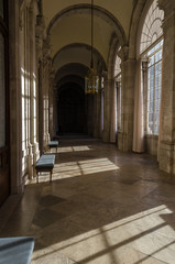 Fototapeta premium Empty hallway of a historic building while sunlight inside through the windows