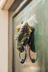 HAARLEM, NETHERLANDS, AUGUST 2019: Dragon shaped door knob from the Middle Ages in the ancient city of Haarlem, Holland