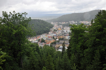 Fototapeta na wymiar Neighborhoods of residential buildings in the historical part of Karlovy Vary surrounded by wooded hills
