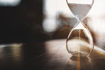 Double exposure of open road and hourglass for about time of journey life concept. 
