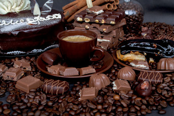 Still-life. Chocolate. Candies. Chocolate cake. Cinnamon. Coffee.