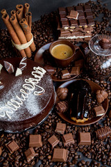 Still-life. Chocolate. Candies. Chocolate cake. Cinnamon. Coffee.