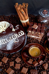 Still-life. Chocolate. Candies. Chocolate cake. Cinnamon. Coffee.