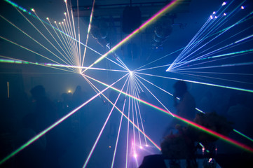 Fototapeta na wymiar laser beam lights at a party with various colors