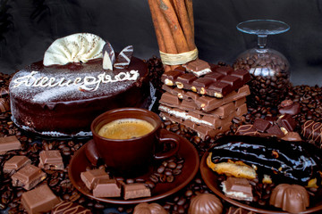 Still-life. Chocolate. Candies. Chocolate cake. Cinnamon. Coffee.