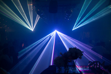 
laser beam lights at a party with various colors