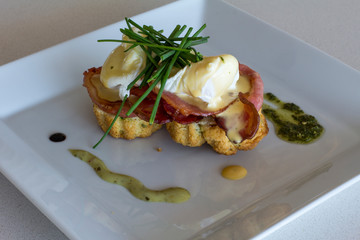 eggs benadict on a white plate