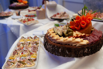 
rolled of fierce and cold salty canapes with white bread stuffed with cold cuts and vegetables and egg decorated with cream