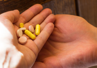 tablets in a man's hand on a white background