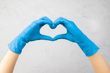 hands in medical gloves show a heart