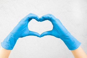 hands in medical gloves show a heart