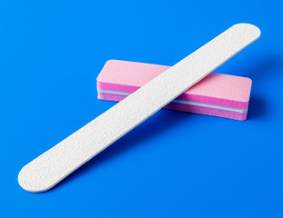 Sanding file sponge for manicure and nailfile on a blue background