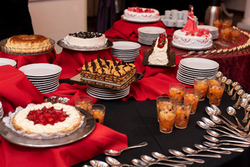 
Sweet chocolate cream cakes and fresh fruits on sweet table at wedding and events