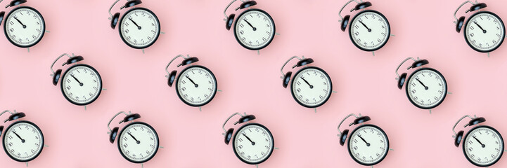 Pattern with black alarm clock on pink background. Minimal style Top view Banner Template for your text, design