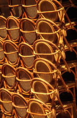 Obraz premium Stacked cane chairs outside closed cafe due to corona crisis