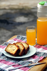 Sliced banana bread loaf and orange juice drink