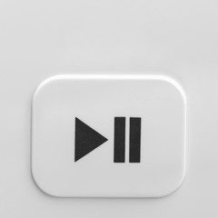 Close-up of the start and pause button on a gray background. Start-up