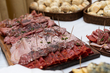 
table of fiembres presented in tables and sources in a banquet with variety of sausages and decoration