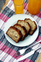 Sliced banana bread loaf and orange juice drink