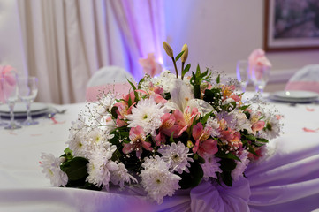 
floral decoration on table in party room for an event, decoration centerpieces with natural flowers
