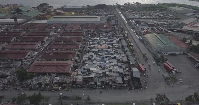 Ungraded, Descending aerial flight towards slums revealing burned building. Drone, 4K. 