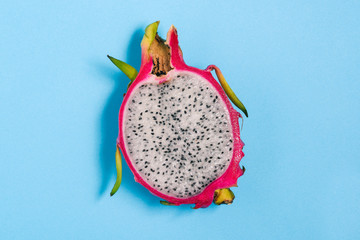 Pitaya fruit isolated on a blue background. Dragon fruit close-up. Summer concept.