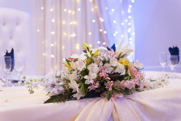 
floral decoration on table in party room for an event, decoration centerpieces with natural flowers
