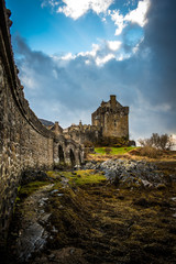 panoramic view on Eileen Donan Castle with a moody cloudy sky 