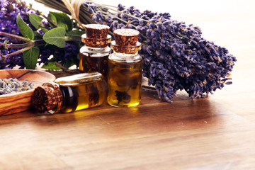 lavender herbal oil and lavender flowers. bottle of lavender massage oil for aromatherapy treatment