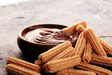 Traditional Spanish dessert churros with sugar and sweet chocolate