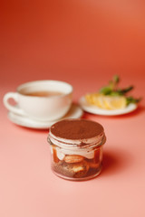 tiramisu, a cup of tea with chopped lemon on an orange background