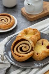 Obraz na płótnie Canvas Danish pastry with coffee cup for breakfast. Cinnamon rools bun.