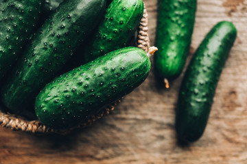 Fresh cucumbers slices on a wooden background. Top view. Copy, empty space for text