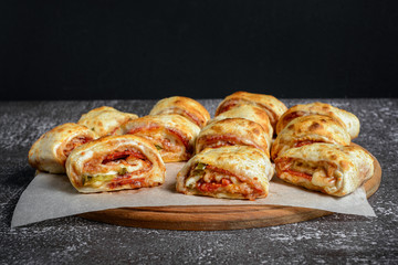 Mini pizza rolls on wooden board