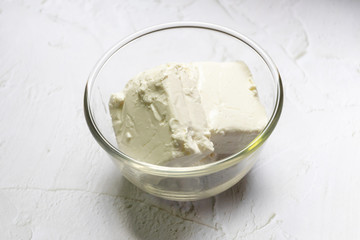 Bowl of cream cheese isolated on white background.