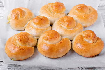 Yeast buns with filling on the parchment paper