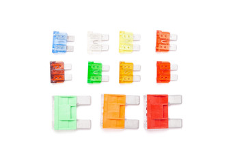 Colorful set of electronic fuses in yellow green orange red and blue on a white isolated background...