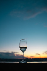 glass of wine on sunset background