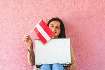 woman with laptop computer and flag of  Austria
