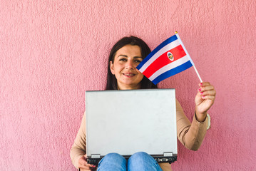 woman with laptop computer and flag of  Costa Rica