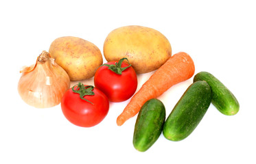 Vegetables (tomato, cucumbers, potatoes, carrot and onions) on white background