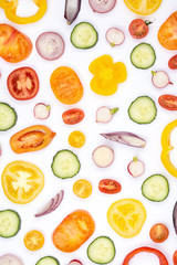 Bright colorful vegetables background. Salad ingredients in various shapes, tomatoes cucumber peppers onions cut on white, top view, selective focus