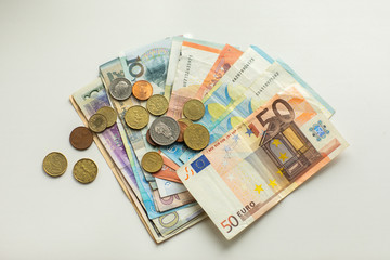 Paper and hard money on white background