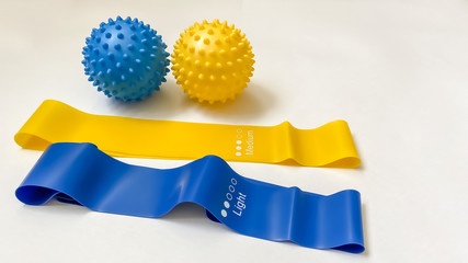 Set of colorful latex rubber bands for fitness on a white background.  massage balls.  sports...