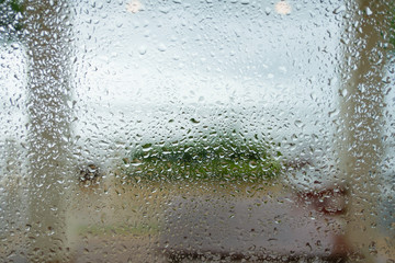 Close up of natural rain drops on window glass surface  used as background.