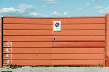 Red metal doors that prevent access to the building